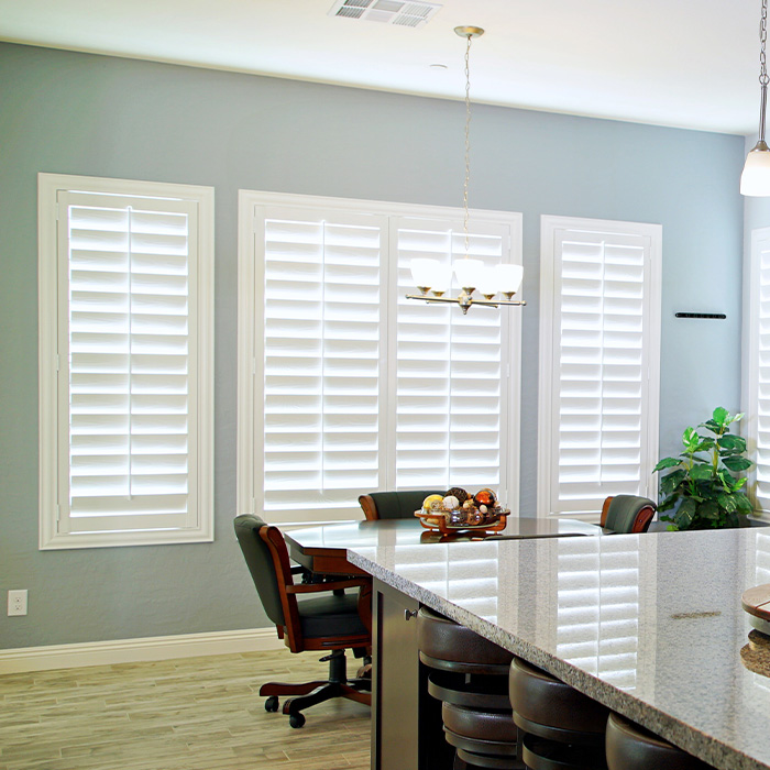 White polywood shutters in a blue and white bathroom.
