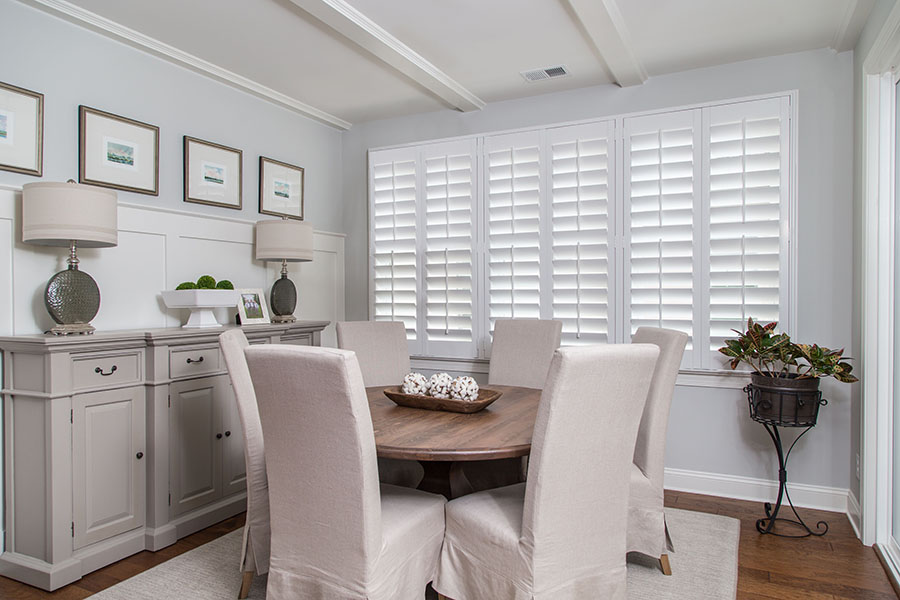 White Polywood shutters in a neutral colored dining room
