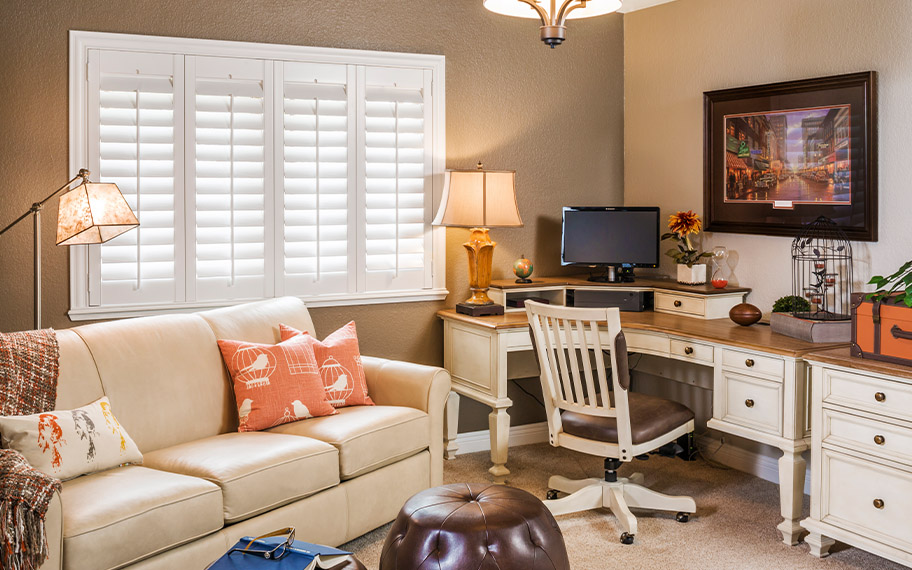 White Polywood shutters in an office living room setting.