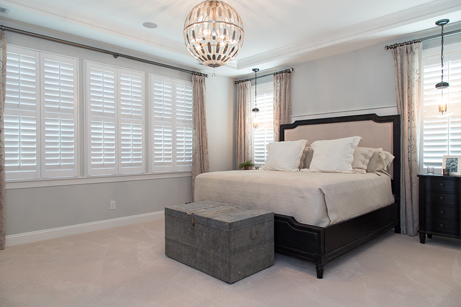 White Polywood shutters within a large bedroom.