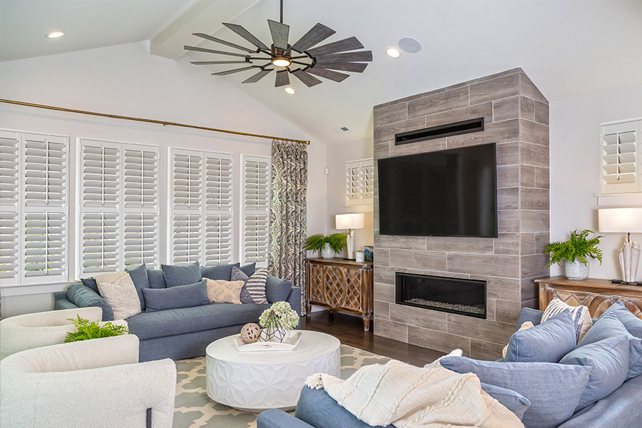 Large media room with white Polywood shutters.